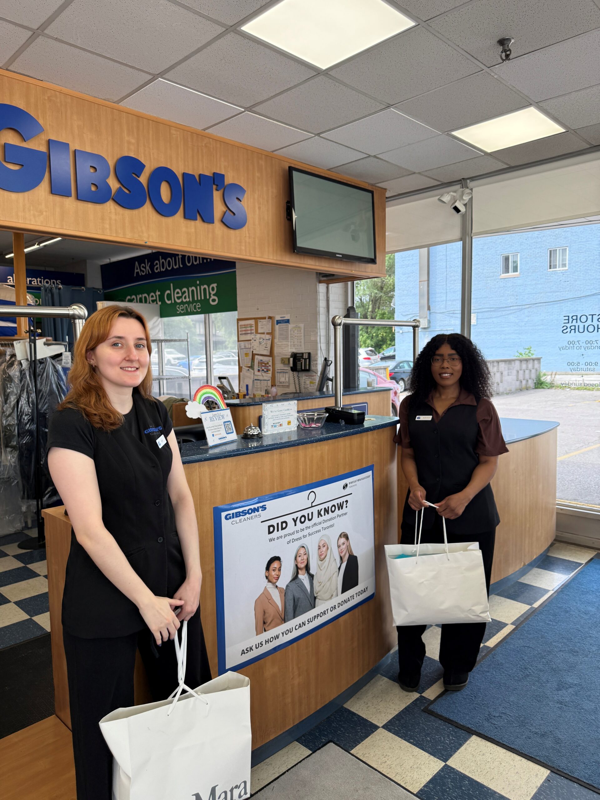 Gibson’s Cleaners team members collecting donated professional clothing