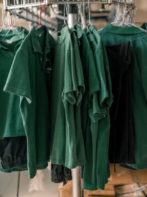 industrial laundry in the hotel clean shirts of employees and guests sorted after washing hang on clotheslines concept cleanliness and hospitality