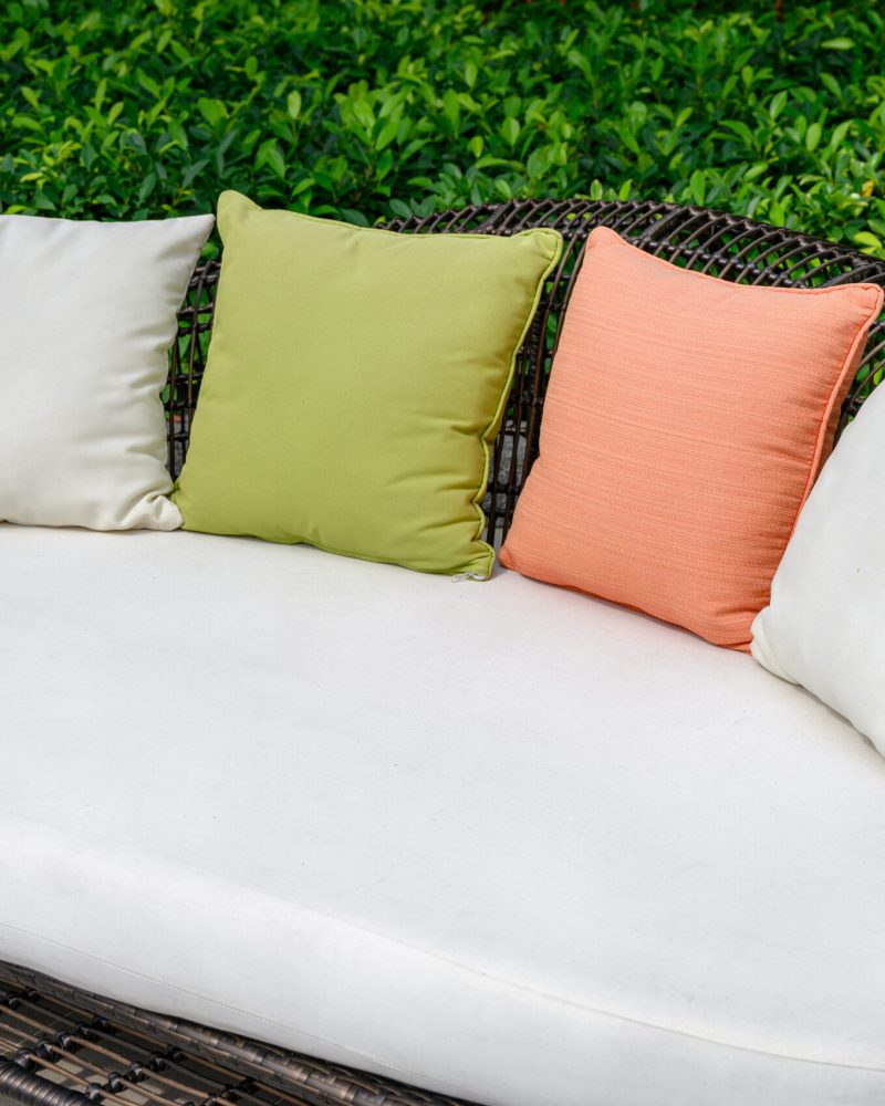 Pillows on mattress and weave wooden sofa in the garden